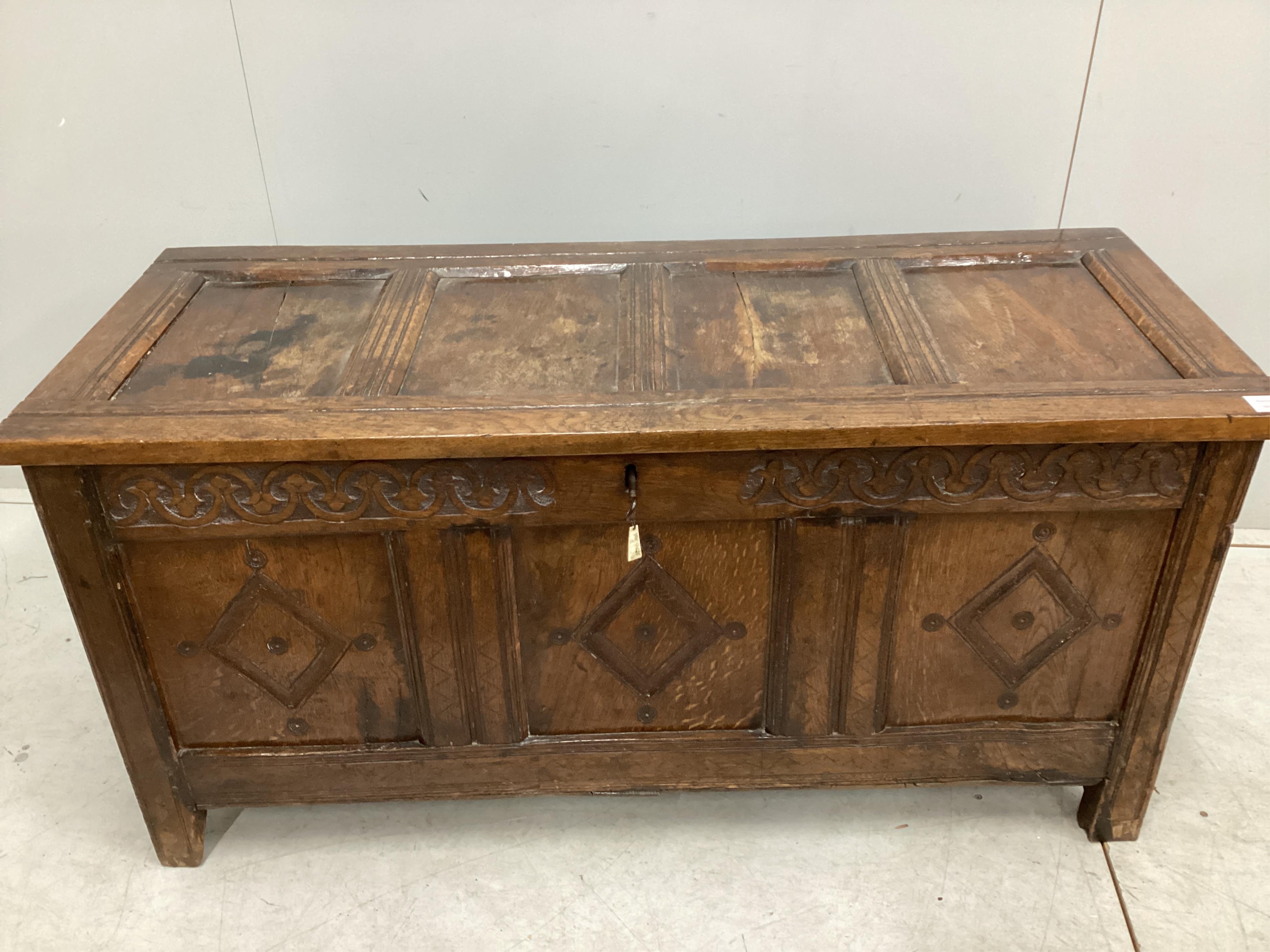 A late 17th / early 18th century panelled oak coffer, width 126cm, depth 51cm, height 62cm. Condition - fair, one top panel split, front probably later carved.